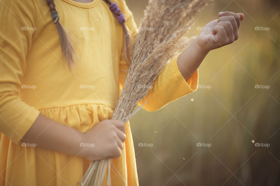 Little girl in yellow dress outdoor portrait 