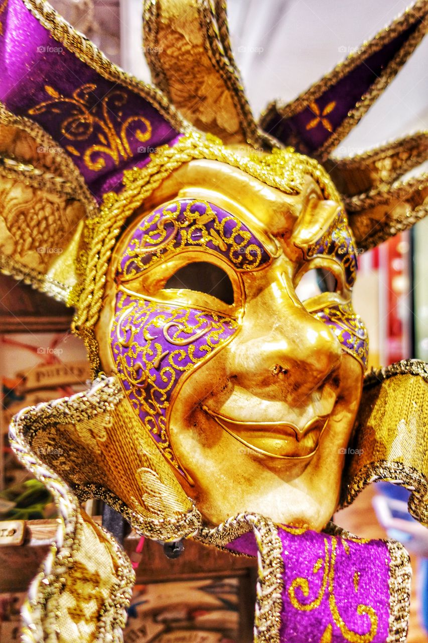 Ornate handmade Venetian mask on display. Image captured from a shop window at the French Quarter, New Orleans, Louisiana, USA.