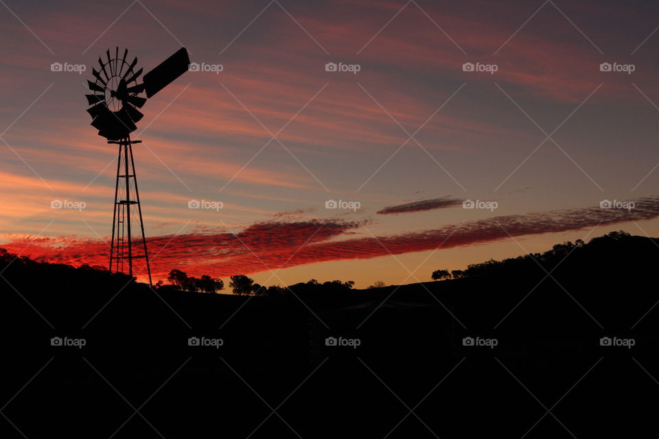 Windmill blowing in Queensland sunset