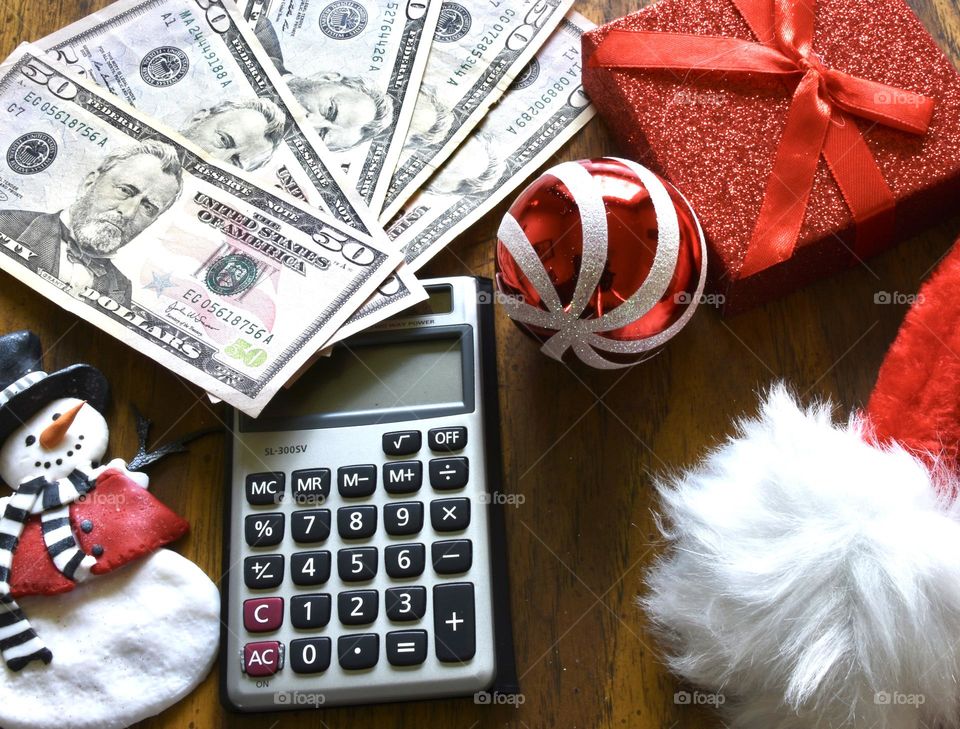 Christmas shopping money with calculator and gift