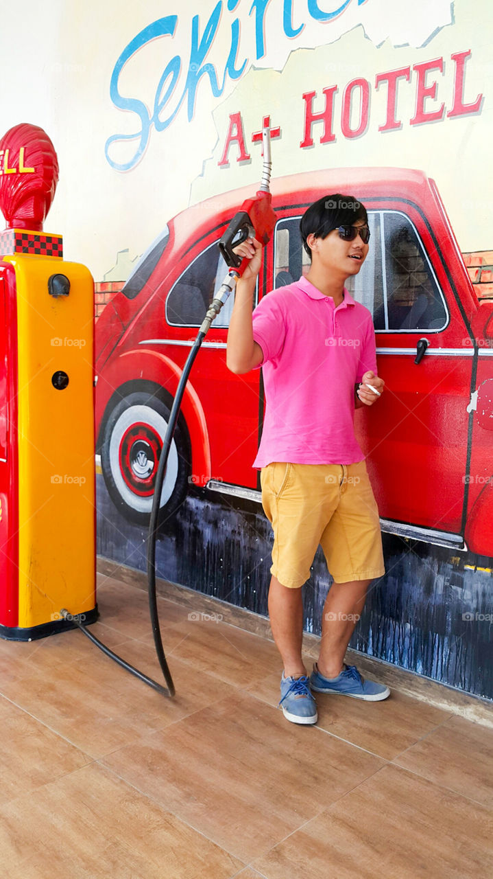 Boy holding gas pump