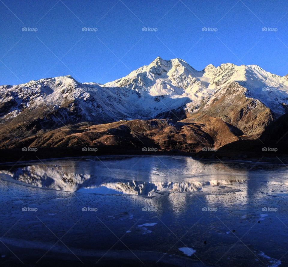 Snow covered mountains reflecting on the lake