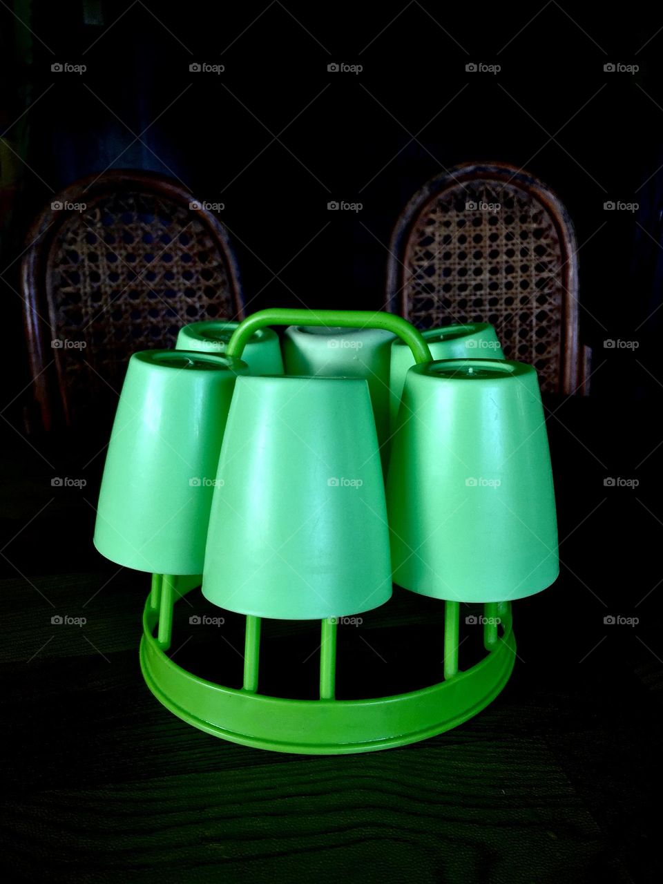 Plastic wares on the table with two rattan chairs 