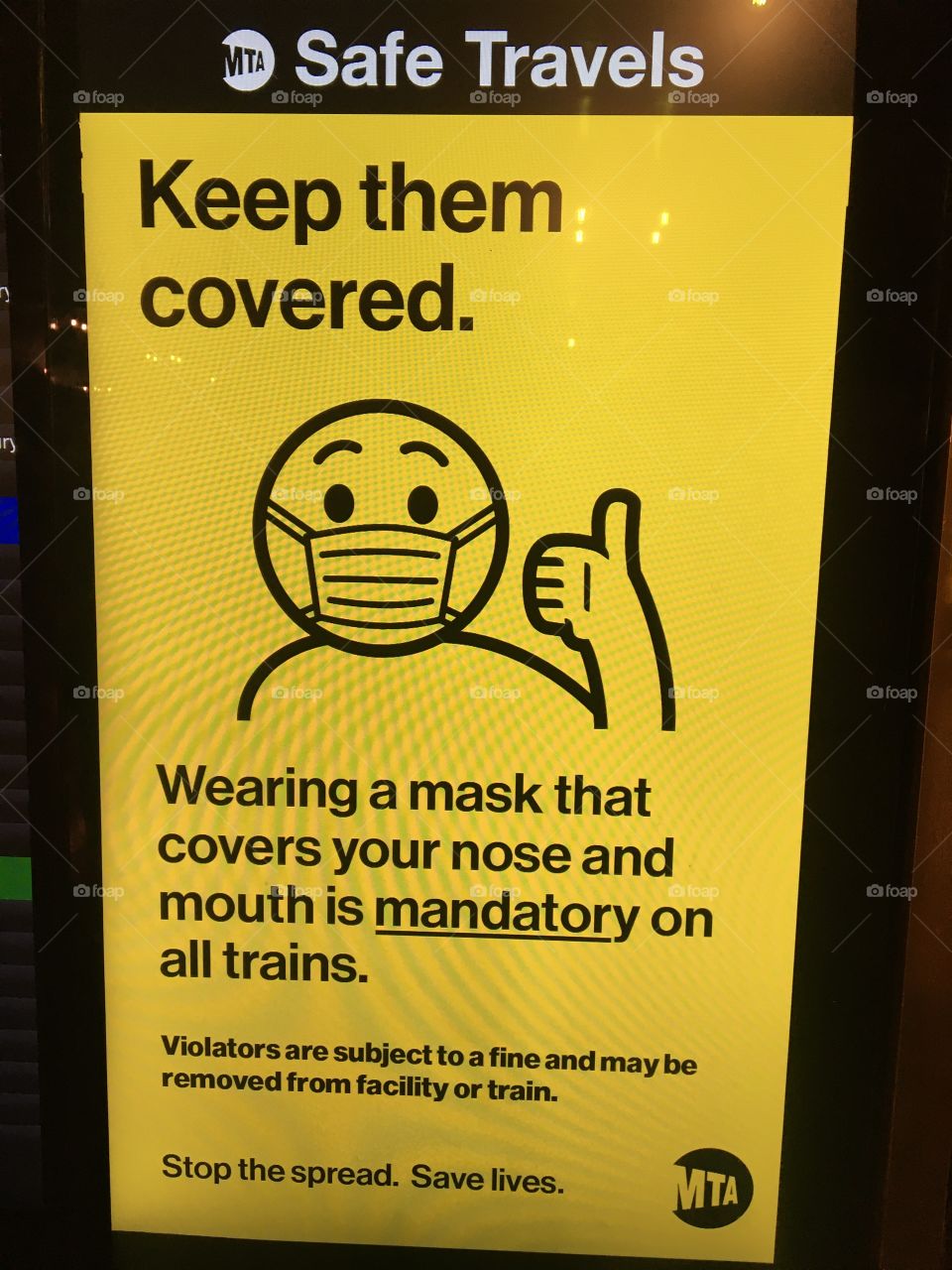 Cute Coronavirus mask instruction sign with cartoon-like man wearing mask directing “keep them covered” in New York City’s Grand Central Station 