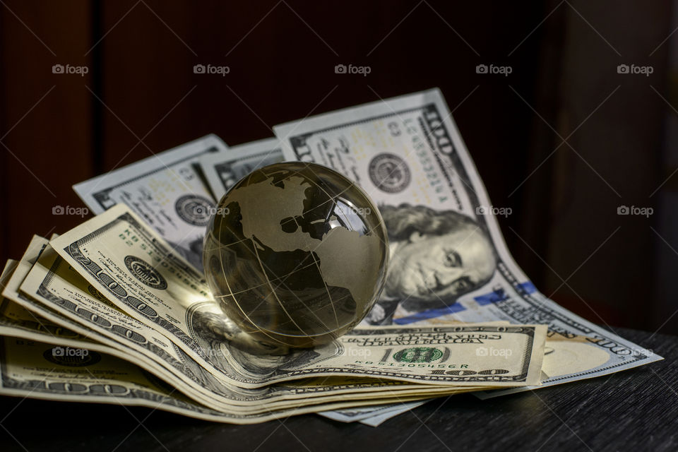 transparent globe on dollars