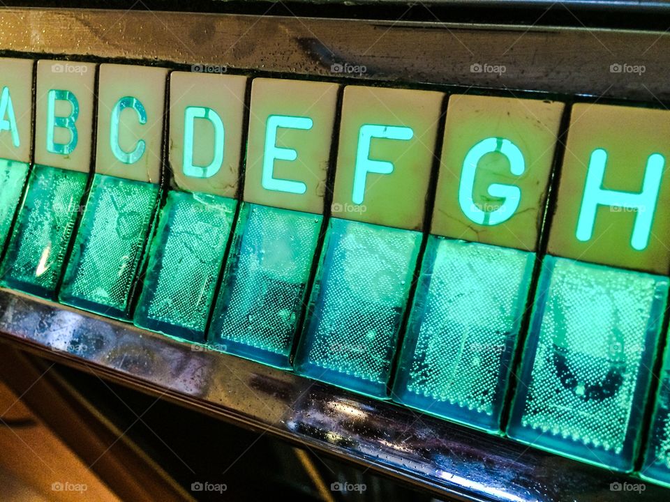 Juke box buttons. Put a quarter in the slot and push the buttons that match the song you want to play on the juke box. G-2. 