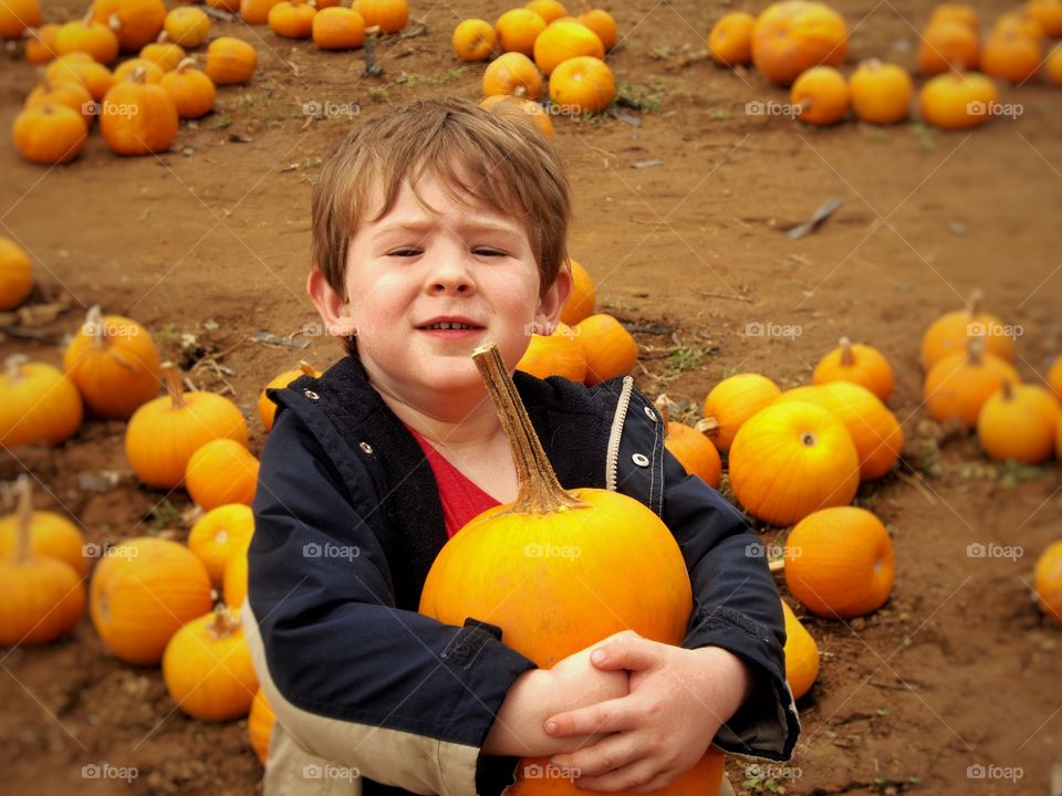 Boy holding pumpkin