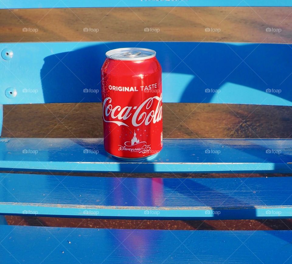 A can of Coca Cola on a blue chair in Nice.