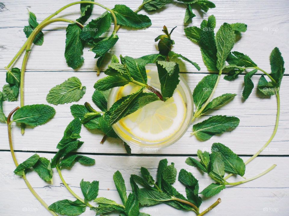 glass of lemonade with lemon and mint leaves