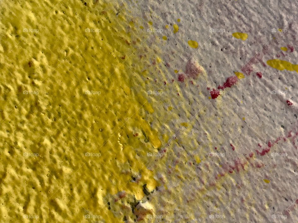 Yellow and Red Paint on Rough Cement