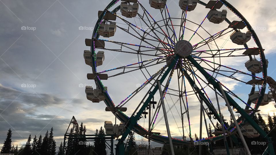 Ferries wheel during fall after the rain at sunset