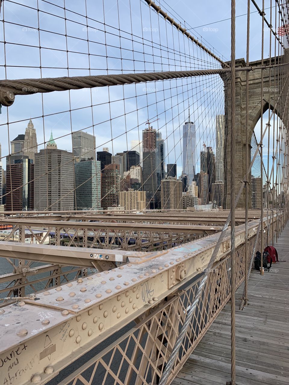 The cable wires on the Brooklyn Bridge with a slant view of Manhattan side of the arch