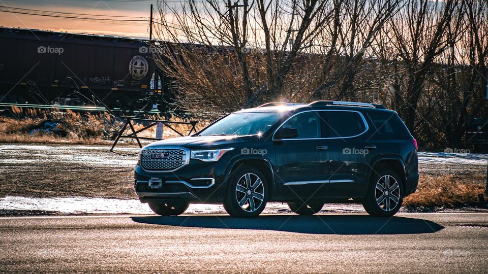 GMC driving past the train.