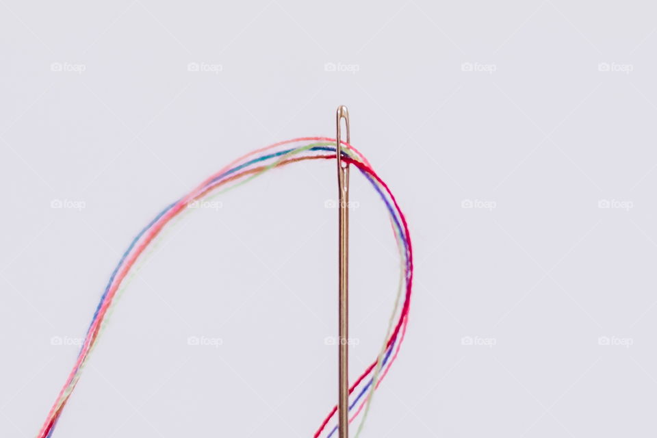 Thread going through a needle
