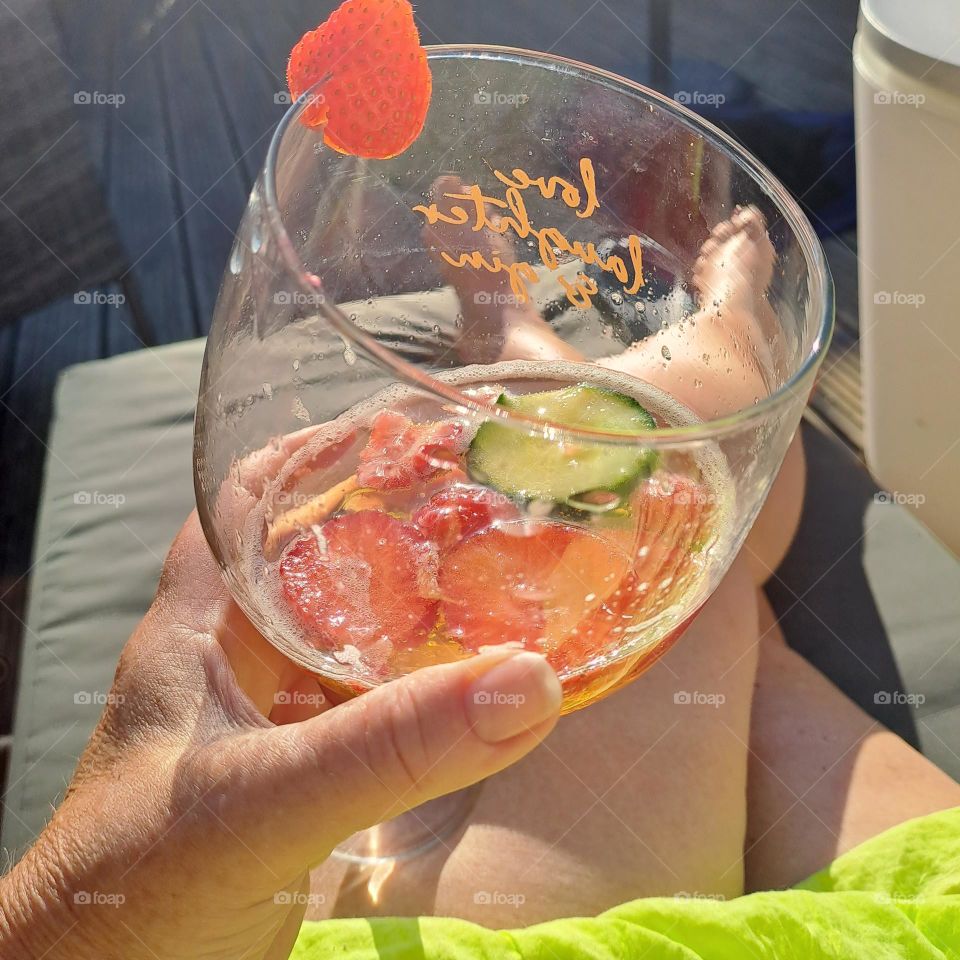 summer afternoon Pimms drink glass fruit sunbed ladies legs and feet