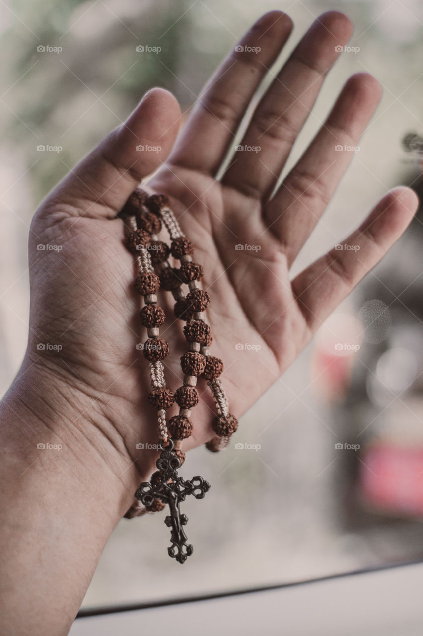 Close-Up Hand holding Rosary beads