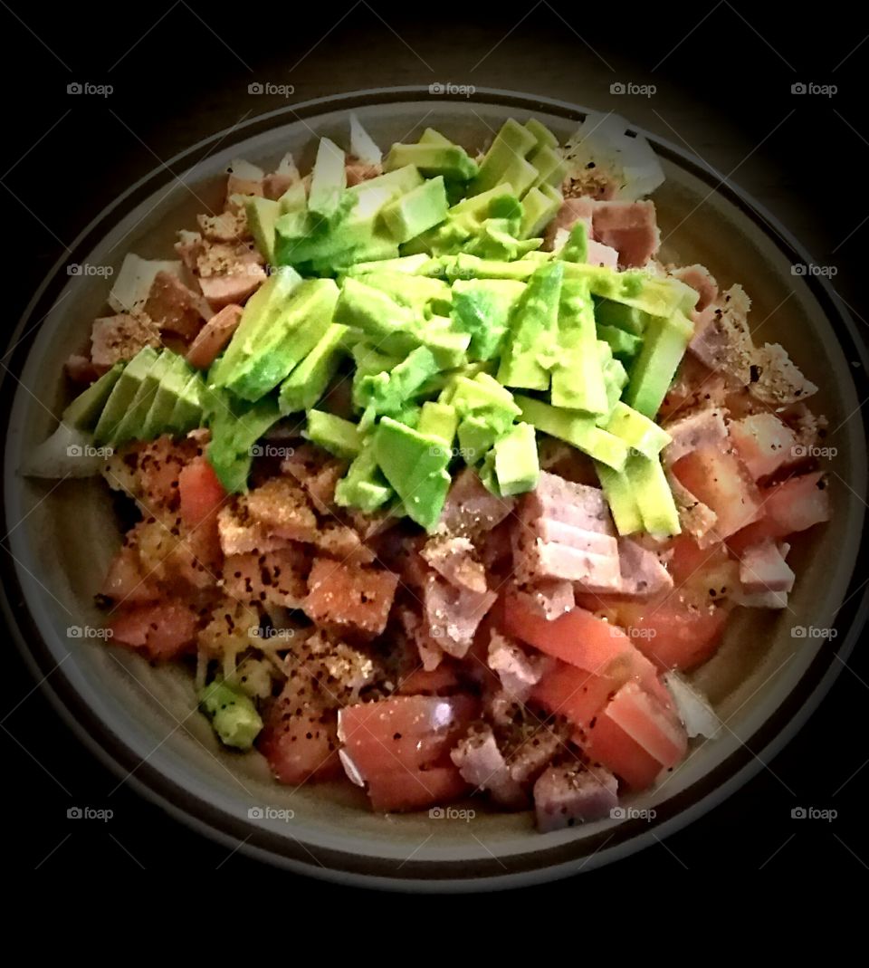 cabbage salad topped with avocado and other delicious ingredients.