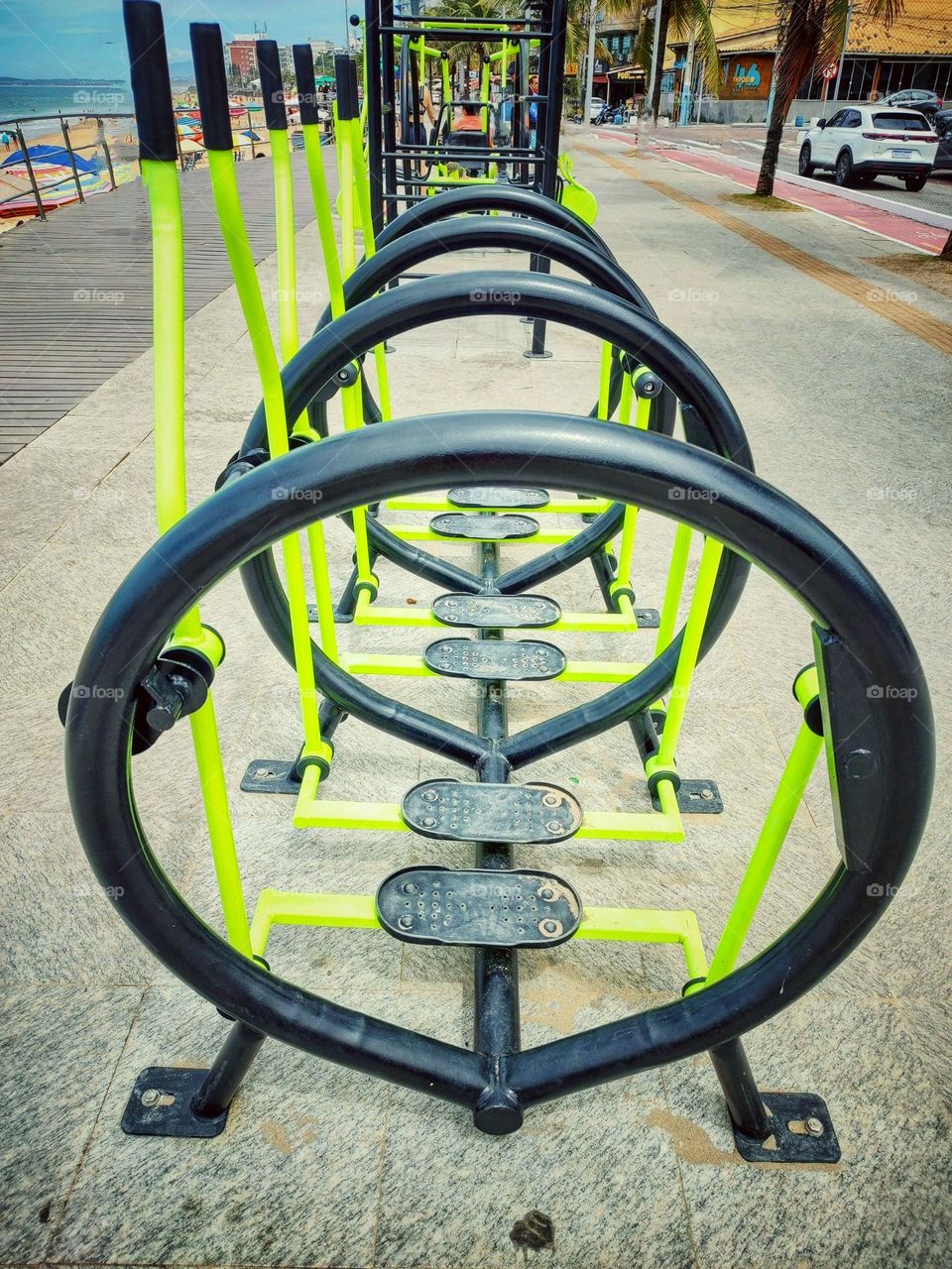 gym equipment, on the boardwalk, so people can work out.an outdoor gym.  A healthy way to exercise.