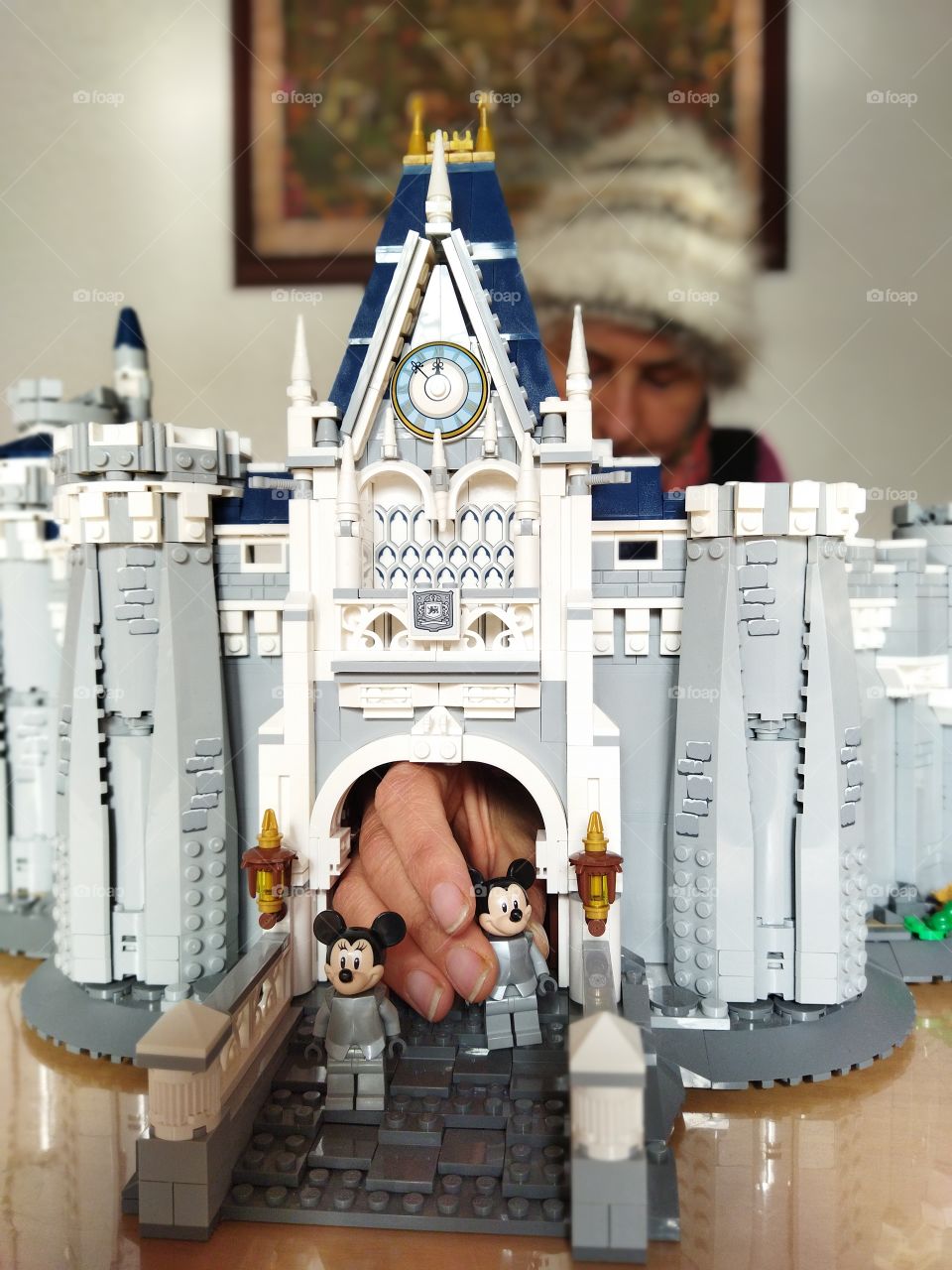 Lego castle with Knight Mickey and Minnie mouse image of woman building Lego and placing figurines