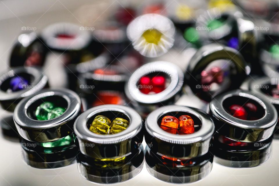 Beautiful hematite necklace with multi colored beads, rainbow pride, reflecting off a mirrored surface 