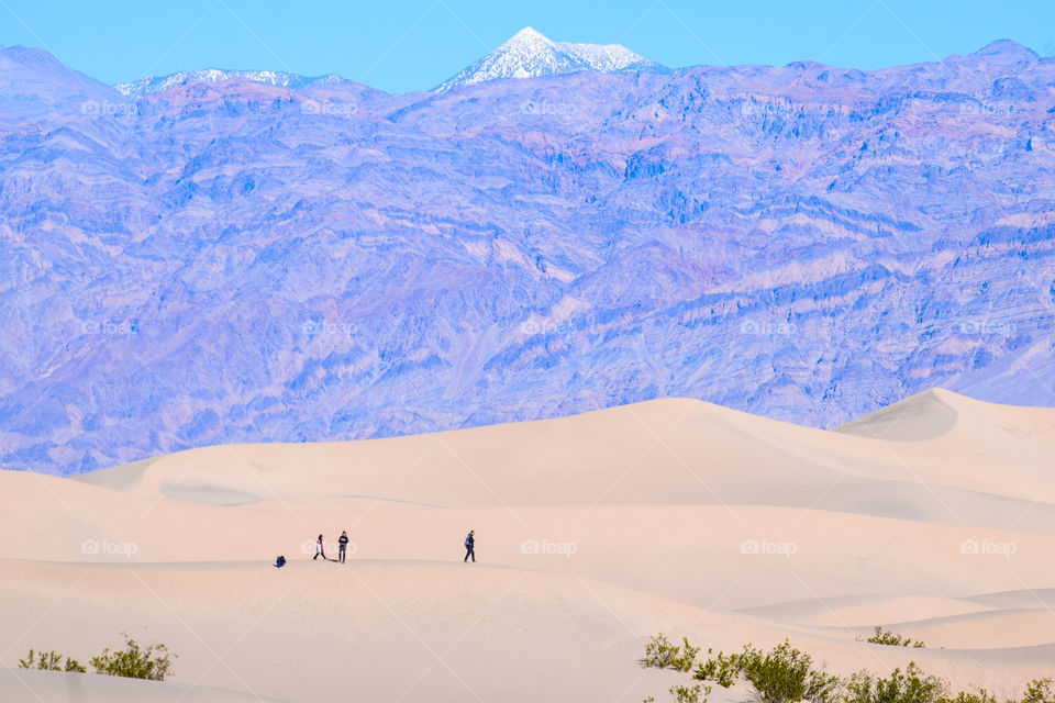 Beautiful white sand dunes against the backdrop of mountains.