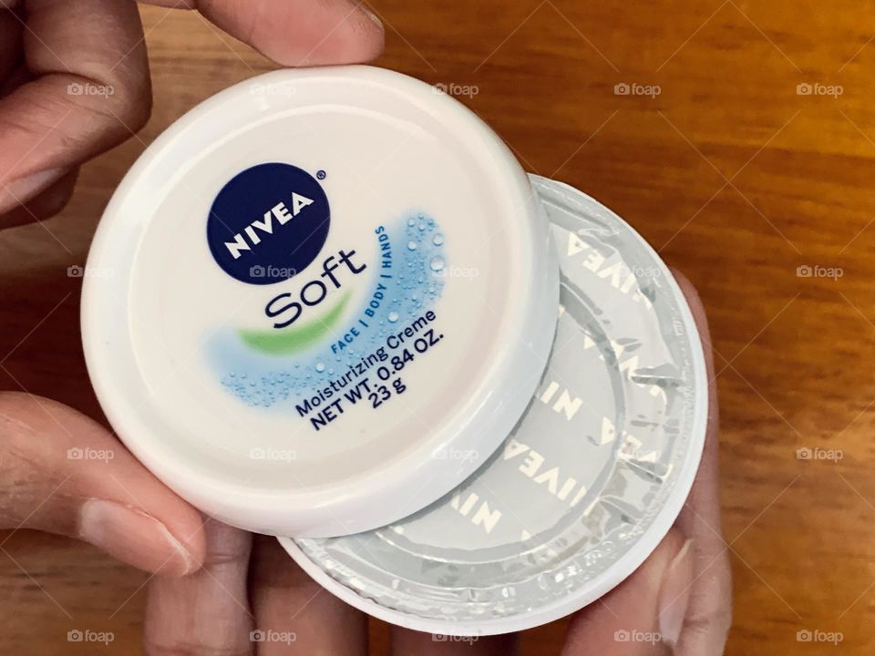 Opening the Nivea soft moisturizing creme