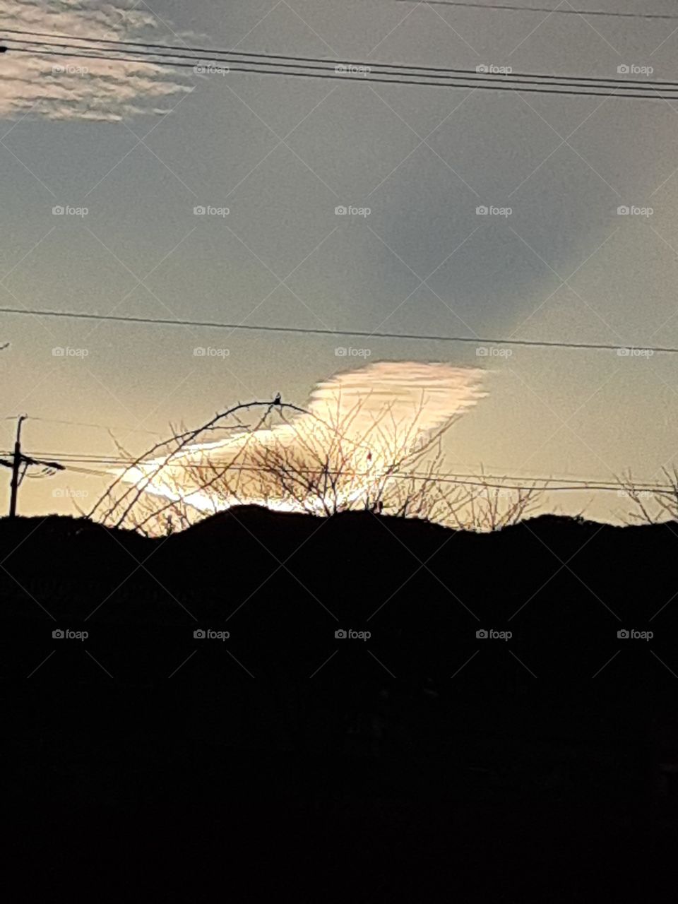 a bird clouds that lights. it's like a foap that's shining bright in everyone's  life.