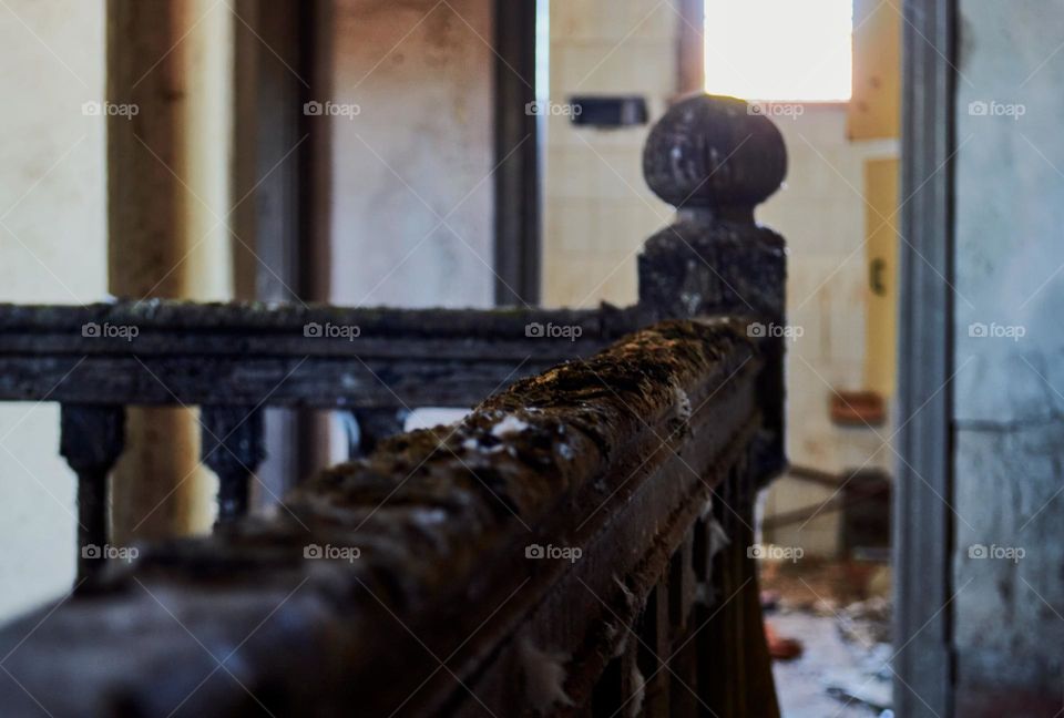 Stair railing of an abandoned house with pigeon poop in a rural town in the province of Santa Fe Argentina.