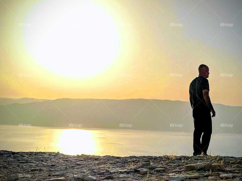 Collecting memories at sunset on the cliff of the Dead Sea
