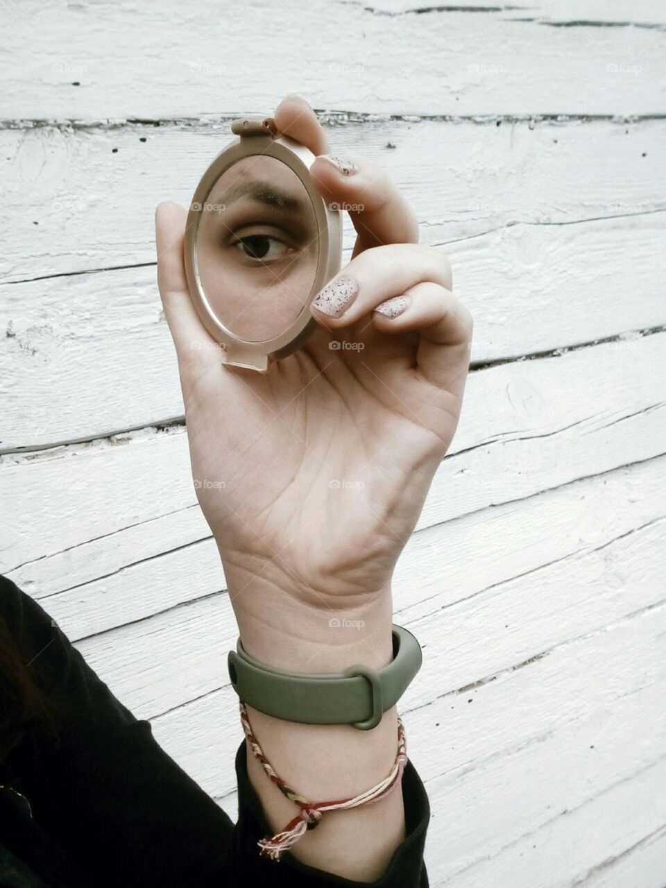 Reflection of a female eye in a round mirror