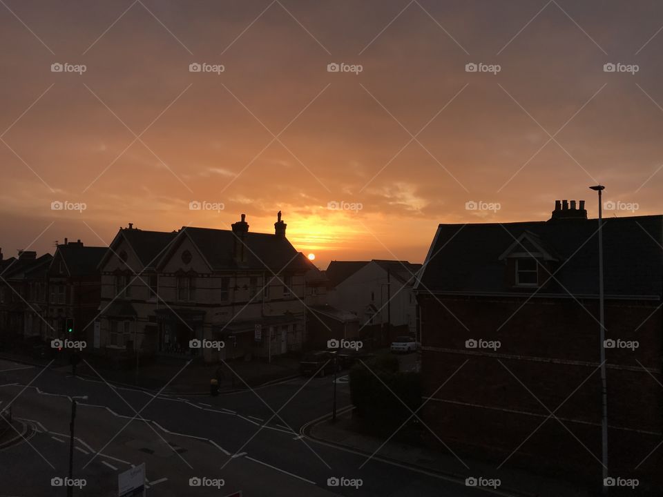 Sunrise in Exeter behind homes