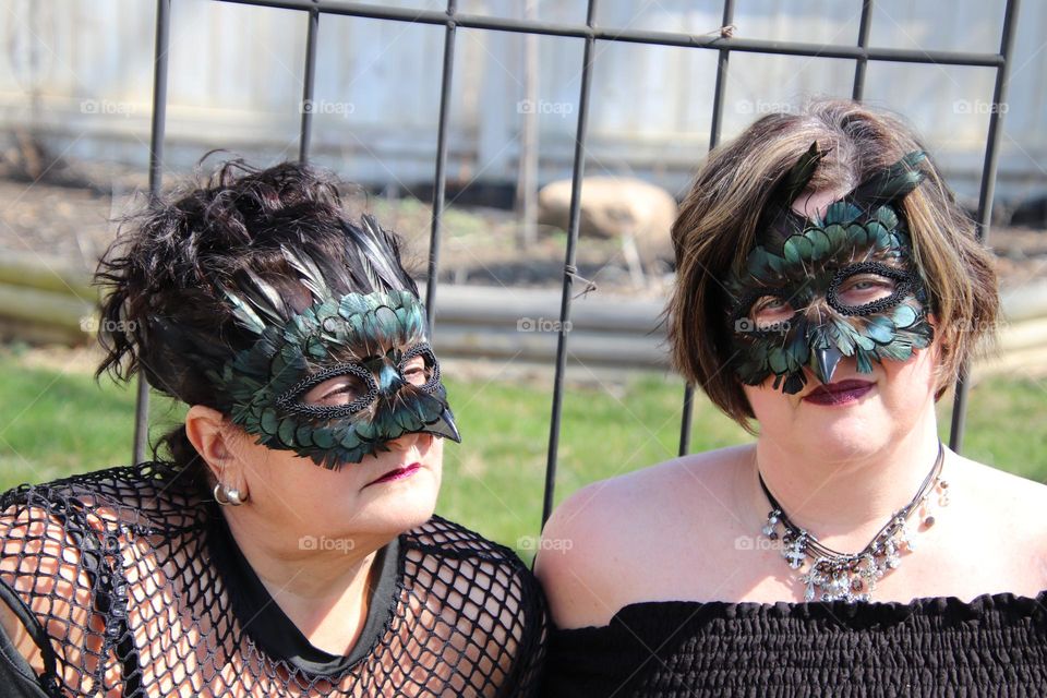 Woman wearing feather masquerade masks