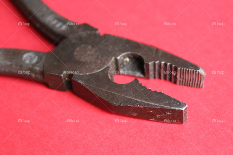 pliers on red background