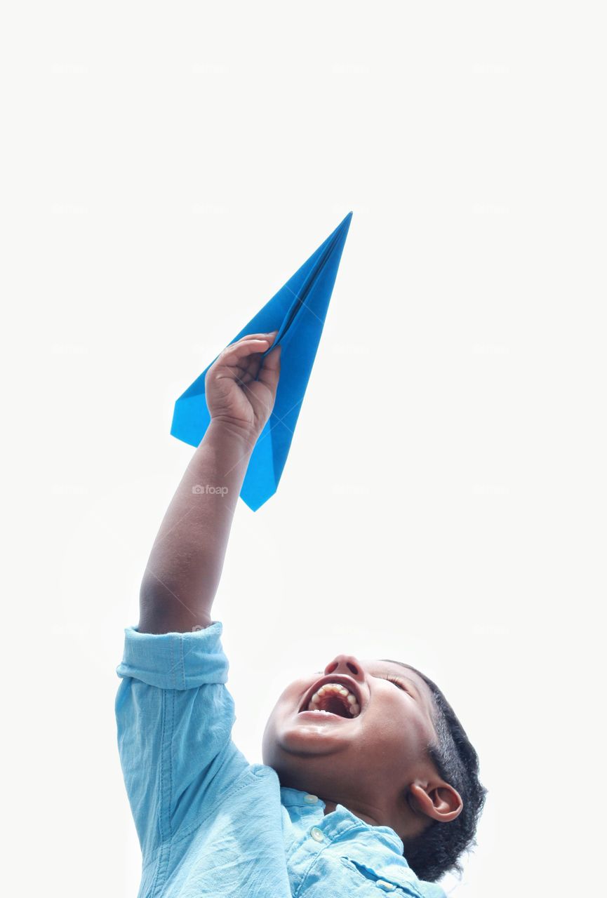 baby boy flying paper plane