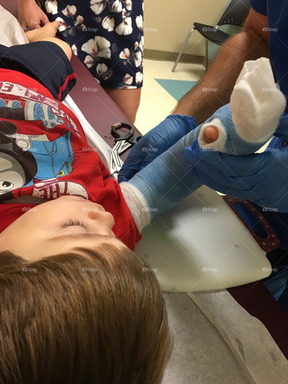 Toddler boy getting a cast.