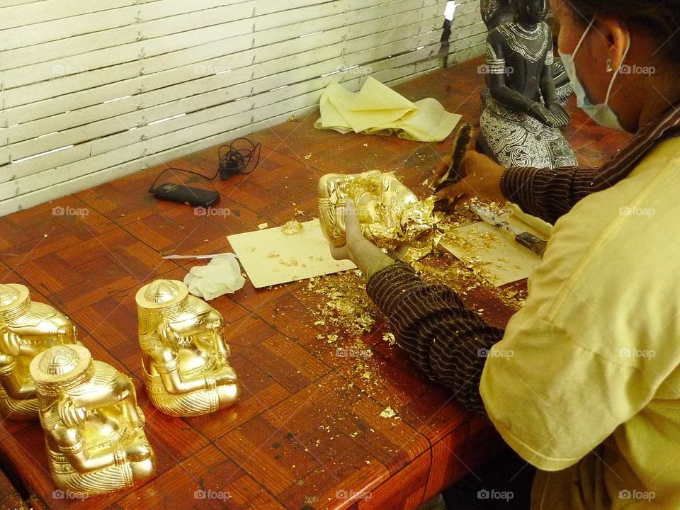 Sculptures being Gilded  in gold in Cambodia