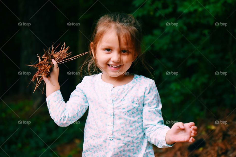 Portrait of girl holding dust