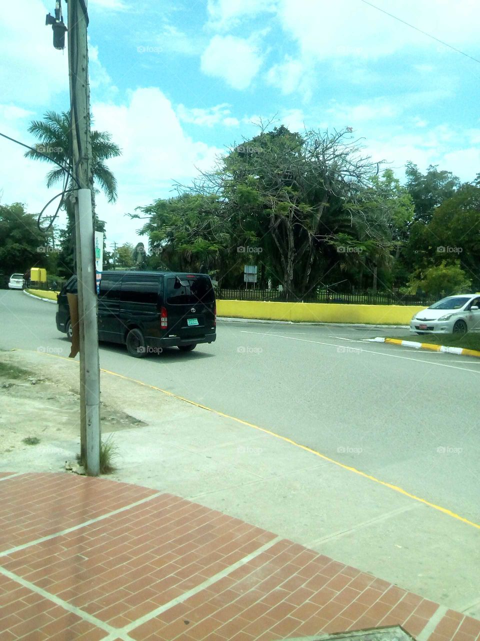 this is wonderful picture it very beautiful to look at you can the van driveing by an the great blue sky .
