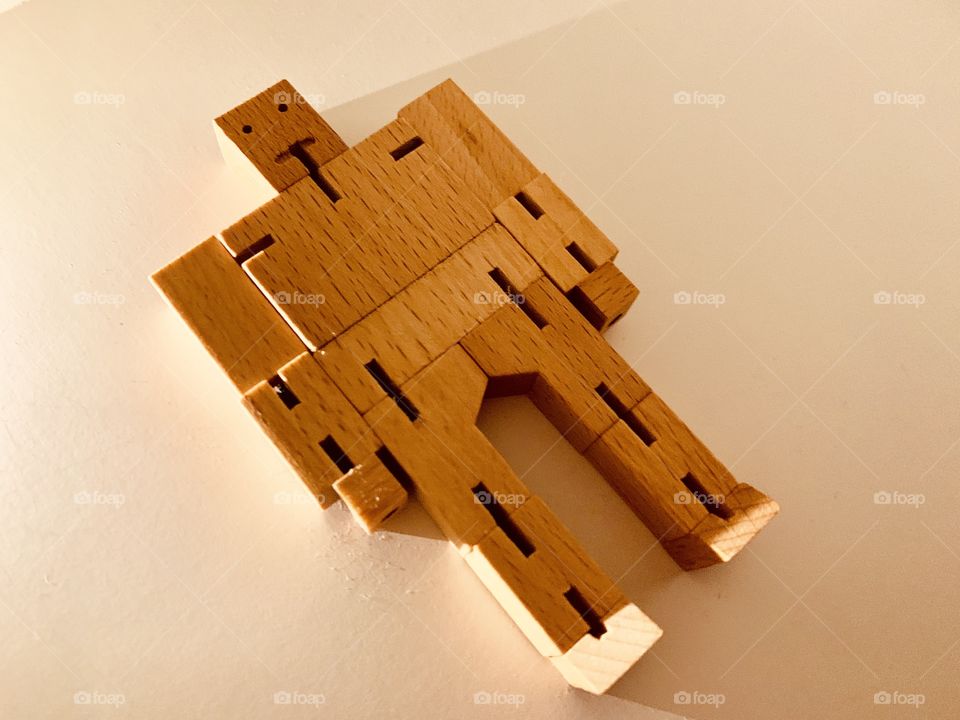 Wooden cube robot chilling on the floor