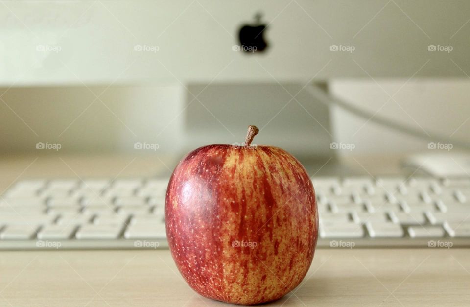 close-up of an apple in front of the Apple computer