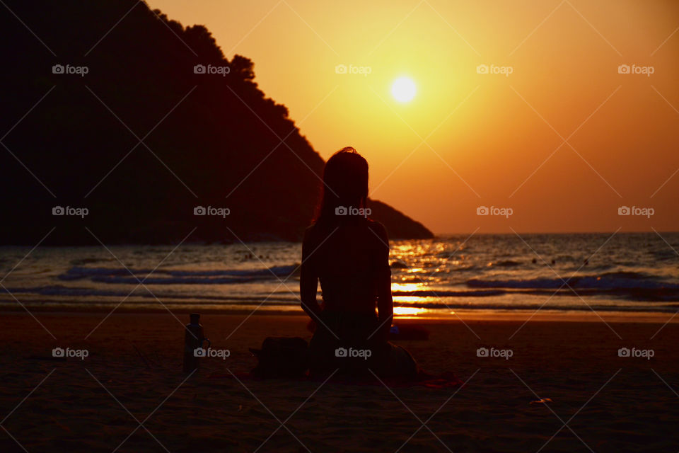yoga in a beach during the sunset
