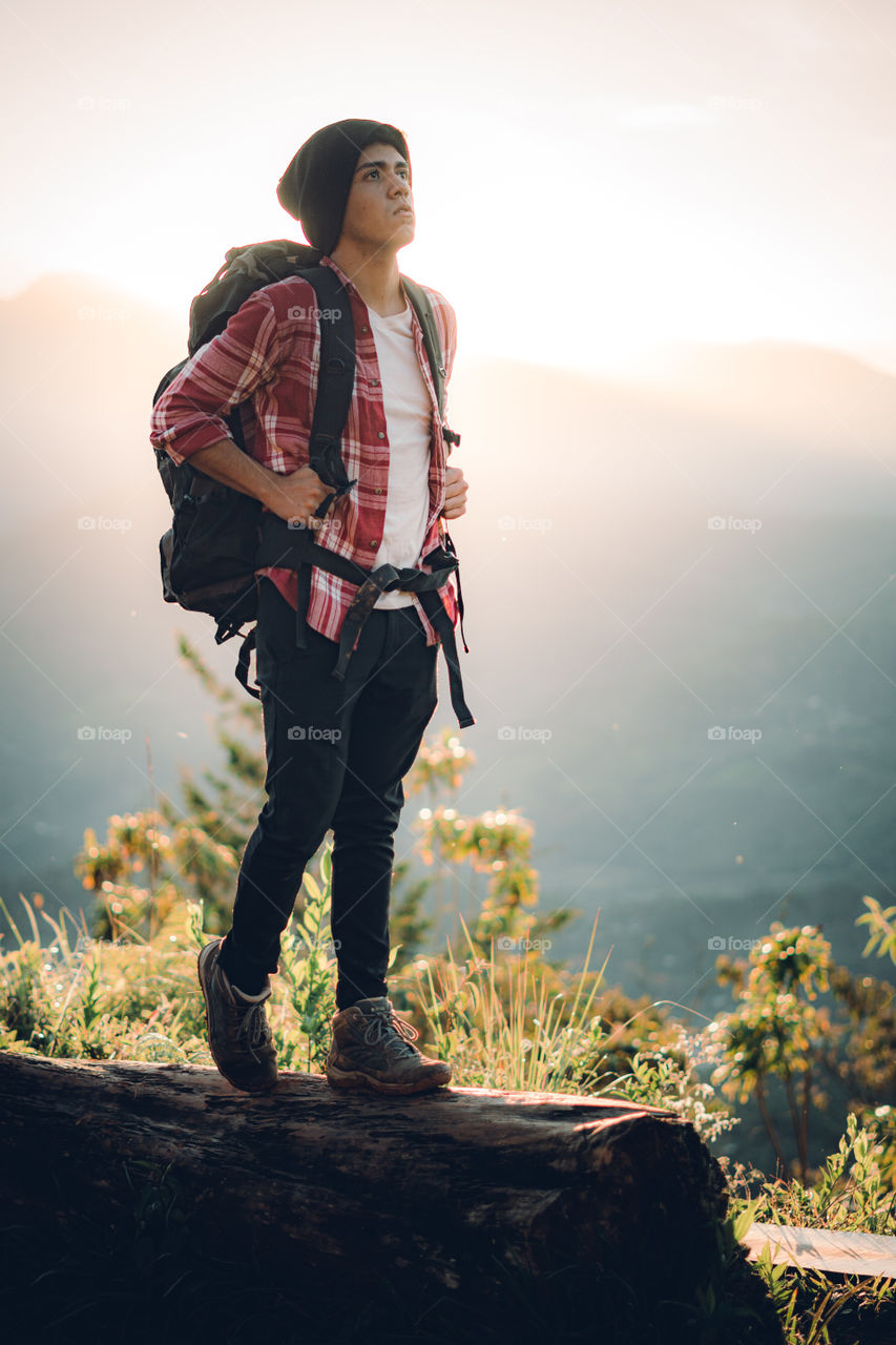 Boy walking on the mountain at dawn in times of social estating