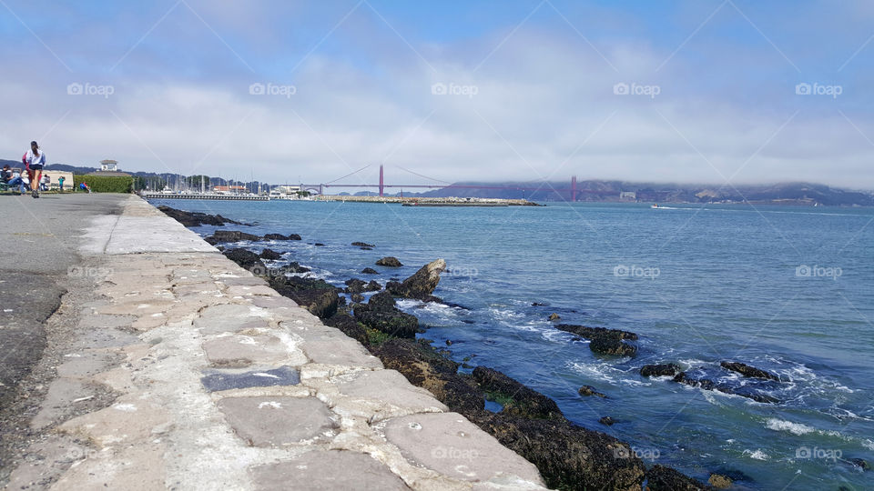 Marina view of the Golden Gate Bridge in San Francisco, jogging by the ocean side