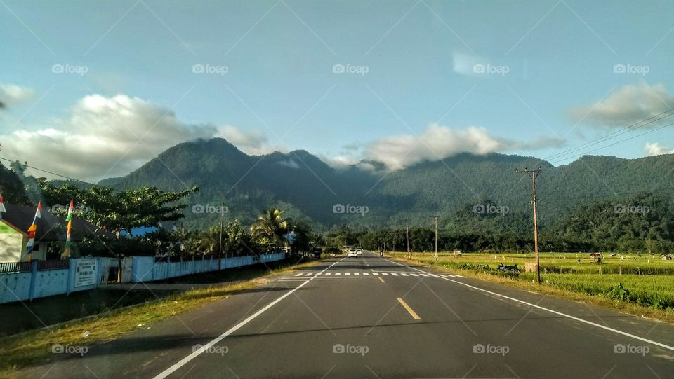 The beautiful mountain view looks from the road with an amazing sky
