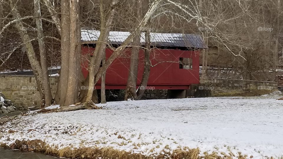 Red covered bridge with winter setting