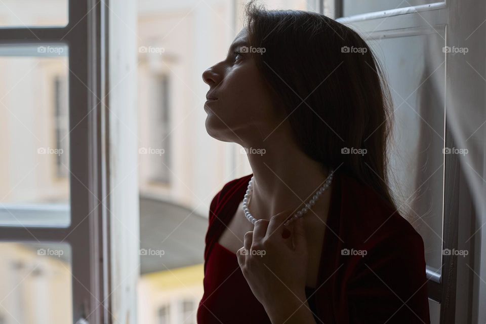 Beautiful girl with pearl necklace for recreation