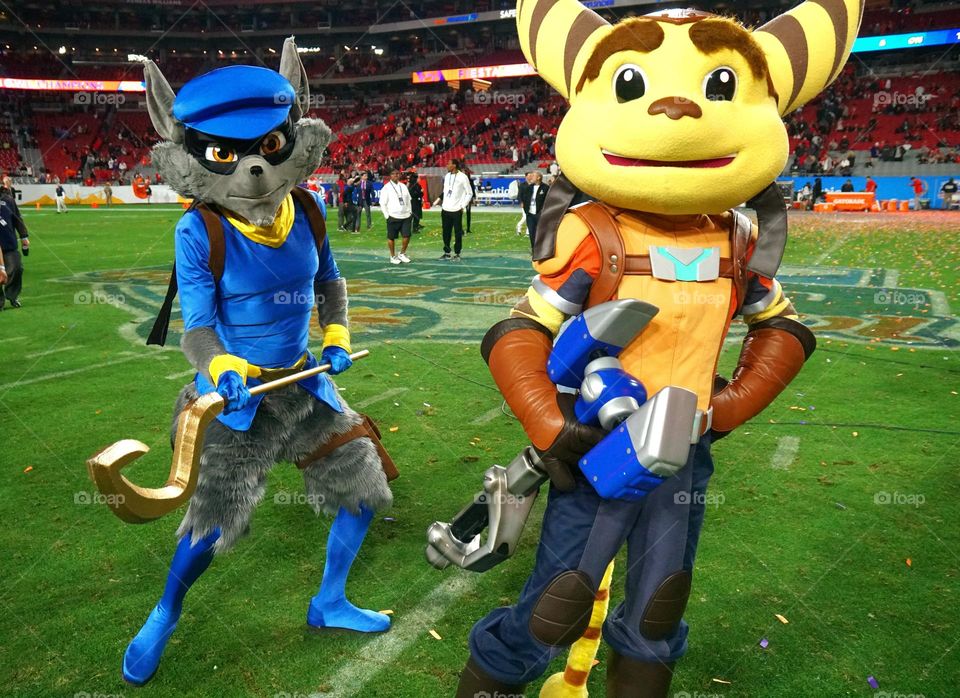 People dress up as video game characters at a major football game that is sponsored by the video console manufacturer