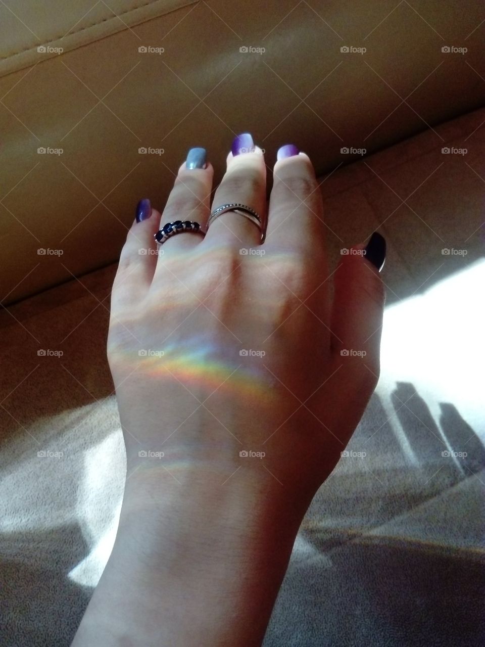 Rainbow and hand with rings