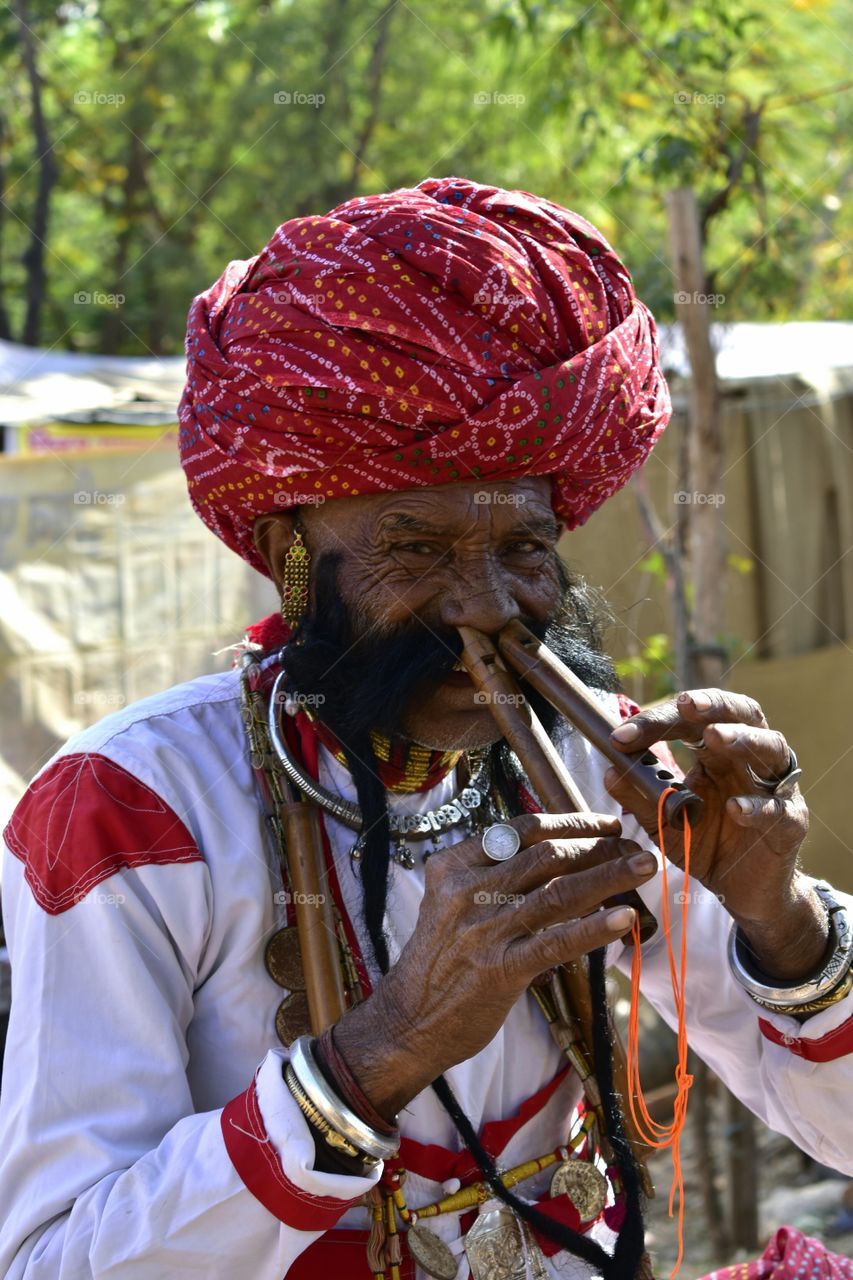 Man playing flute by nose