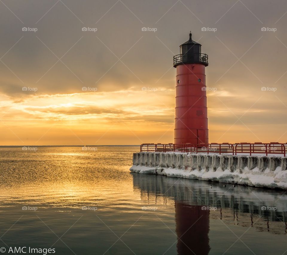 Red light house on Lake Michigan at sunrise in Milwaukee Wisconsin
